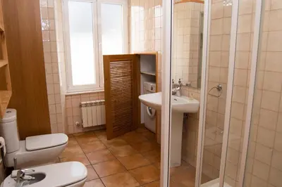 a bathroom with a toilet and a sink at HOLIDAY HOMES Figueras AT in Castropol