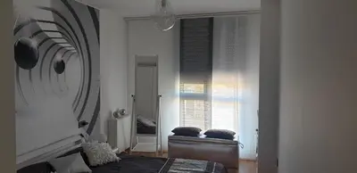 a bedroom with a bed and a large window at Apartamento tranquilo in Ponferrada
