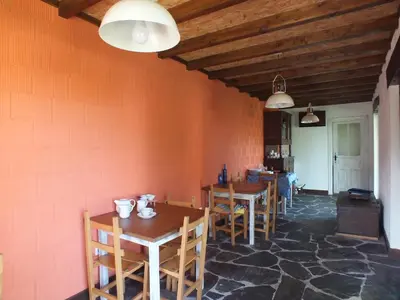 a dining room with wooden tables and chairs at Apartamentos Puerta del Castro in Coaña