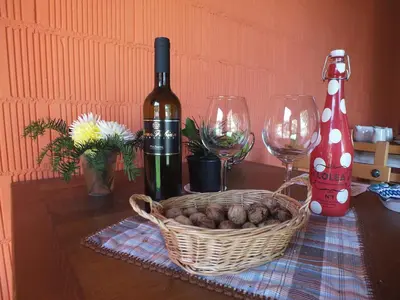 a table with two wine glasses and a basket of mushrooms at Apartamentos Puerta del Castro in Coaña