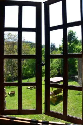 an open window with a view of a park outside at Cabeza da Vila in San Martín de Oscos