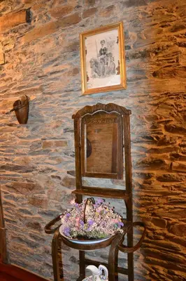 a mirror sitting on a chair in a room at Cabeza da Vila in San Martín de Oscos