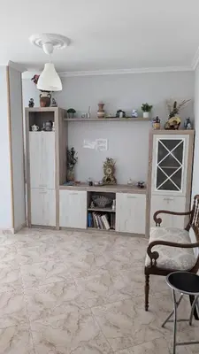 a living room with a table and a chair at Alojamiento Camiño Real in Sigüeiro