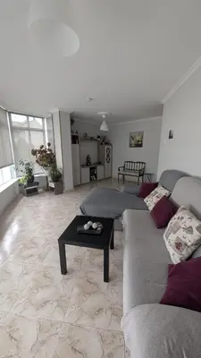 a living room with two couches and a coffee table at Alojamiento Camiño Real in Sigüeiro