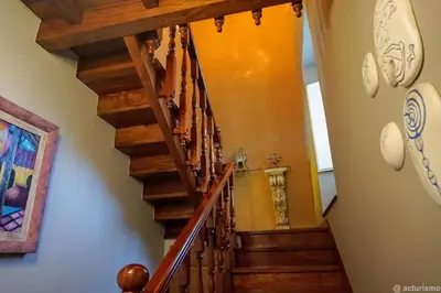 a staircase in a home with a wooden stair case at O Rincón de Mercedes in Jove
