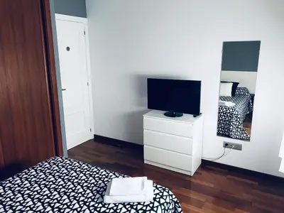 a bedroom with a bed and a tv on a dresser at lucushouse II in Lugo