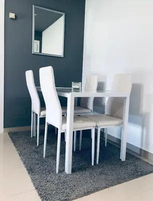 a white dining room table with white chairs and a mirror at lucushouse II in Lugo