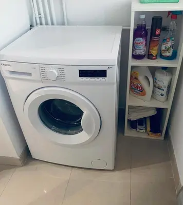 a white washing machine in a kitchen with a shelf at lucushouse II in Lugo