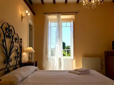 a bedroom with a large bed and a window at Villa Auristela in Navia