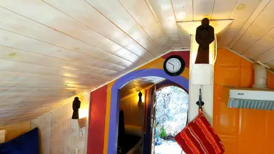 a room with a clock on the ceiling and a hallway at zentralclub apartamento El Nido de Somiedo in Santiago del Hermo