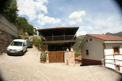 a car parked on a street next to a building at zentralclub apartamento El Nido de Somiedo in Santiago del Hermo