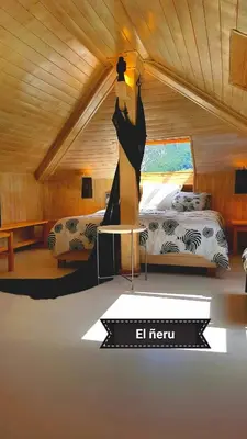 a bedroom with two beds and a table in a room at zentralclub apartamento El Nido de Somiedo in Santiago del Hermo