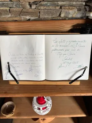 a book on a shelf with writing on it at Hotel rural casa Ferreiro in Seoane