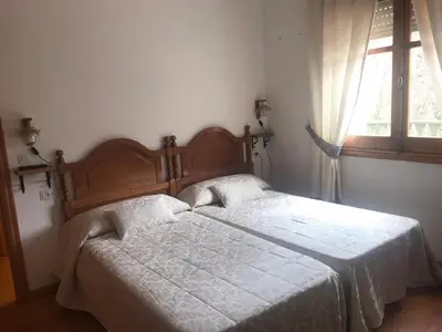 a bedroom with a bed and a window at Hotel rural casa Ferreiro in Seoane