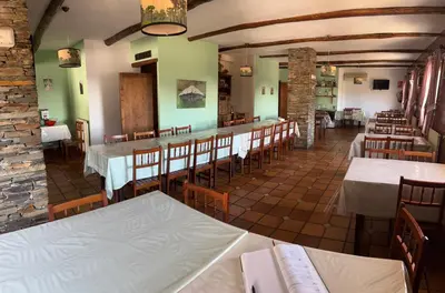 a restaurant with tables and chairs in a room at Hotel rural casa Ferreiro in Seoane