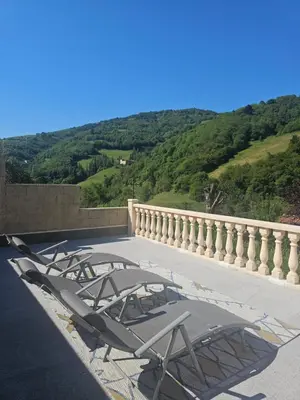 a group of chairs sitting on a balcony with a view at Casa Rural La Pumarada de Limés in Cangas del Narcea