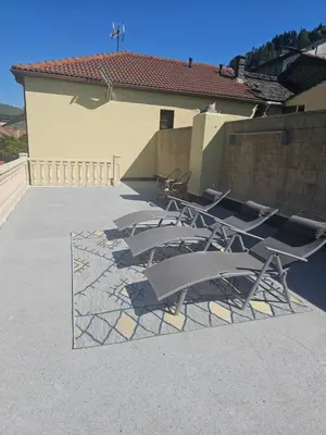 a group of chairs sitting outside of a building at Casa Rural La Pumarada de Limés in Cangas del Narcea