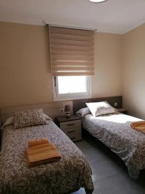 a bedroom with two beds and a window at Casa IRIENSE VUT-CO-004308 in Padrón