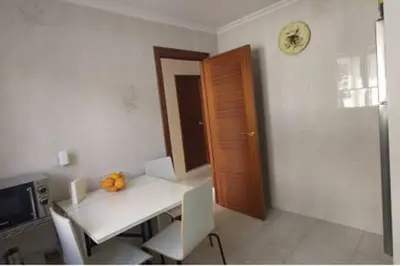 a room with a table and a clock on the wall at Casa IRIENSE VUT-CO-004308 in Padrón