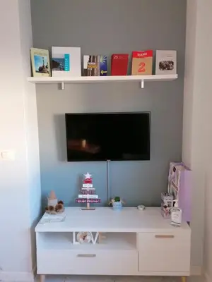 a white entertainment center with a tv on a wall at Casa IRIENSE VUT-CO-004308 in Padrón