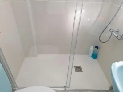 a bathroom with a shower with a toilet and a sink at Casa IRIENSE VUT-CO-004308 in Padrón