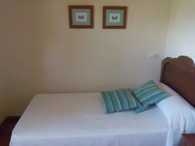 a bed with two pillows on it in a bedroom at Casa Crisanta in Lomba