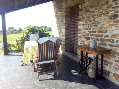 two rocking chairs and a table on a patio at Casa Crisanta in Lomba