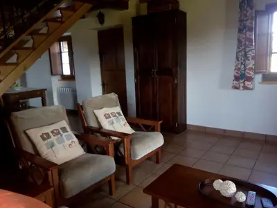 a living room with two chairs and a table at Casa Crisanta in Lomba