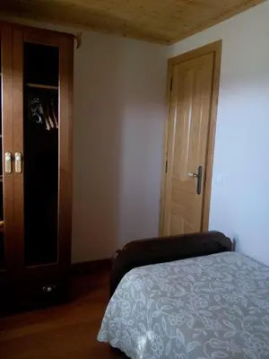 a bedroom with a bed and a closet and a door at Casa Crisanta in Lomba