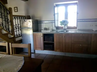 a kitchen with a refrigerator and a window at Casa Crisanta in Lomba