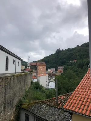 a view of a city from the roofs of buildings at La Capilla del Corral in Cangas del Narcea