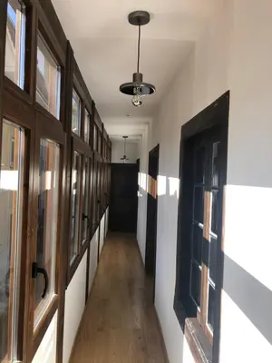 a hallway with wooden doors and a hallway with a hallwayngth at La Capilla del Corral in Cangas del Narcea