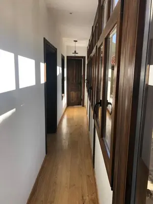 a hallway of a house with wooden floors and a door at La Capilla del Corral in Cangas del Narcea