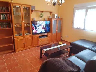 a living room with a couch and a tv at Casa César in Barreiros
