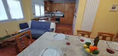 a kitchen and dining room with a table with fruit on it at Casa César in Barreiros