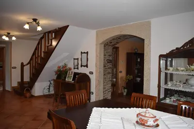 a stone fireplace in a room with a stone wall at Casa Bama in Bama