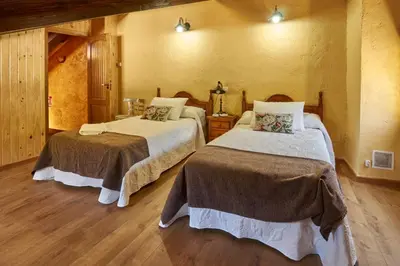 a bedroom with two beds in a room at casa el susurro in Ponferrada
