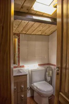 a bathroom with a toilet and a sink at casa el susurro in Ponferrada