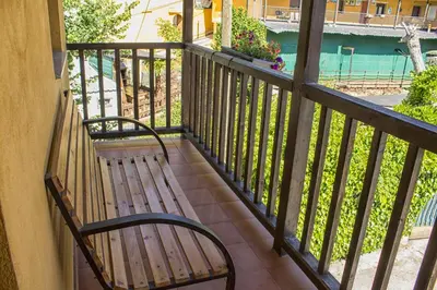 a bench sitting on a balcony looking out at the water at casa el susurro in Ponferrada