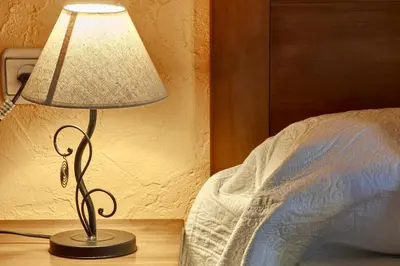 a lamp sitting on a table next to a bed at casa el susurro in Ponferrada
