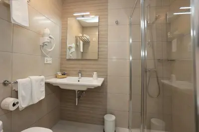 a bathroom with a sink and a shower at Hotel Ros Mary in Ribadeo
