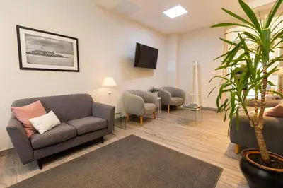 a living room with two couches and a plant at Hotel Ros Mary in Ribadeo