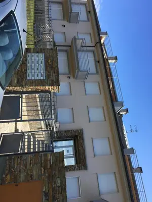 a tall white building with balconies and fire escapes at Apartamento Playa San Pedro in Barreiros