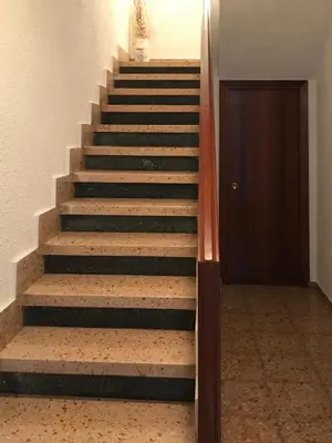 a set of stairs in a building with a door at Casa de la Abuela in Fabero