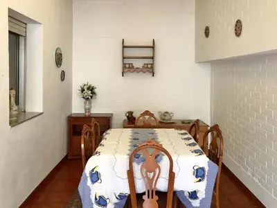 a dining room with a table with a blue and white table cloth at Casa de la Abuela in Fabero