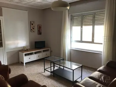 a living room with a couch and a table and a television at Casa de la Abuela in Fabero