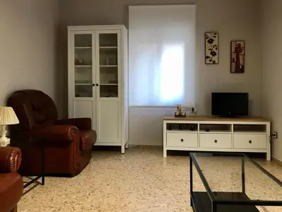 a living room with a tv and a couch and a chair at Casa de la Abuela in Fabero