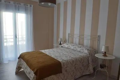 a bedroom with a bed and a large window at Campania in Ourense
