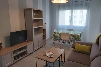 a living room with a couch and a tv and a table at Campania in Ourense