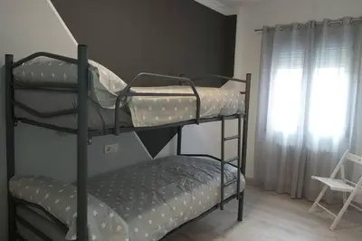 two bunk beds in a room with a window at Campania in Ourense